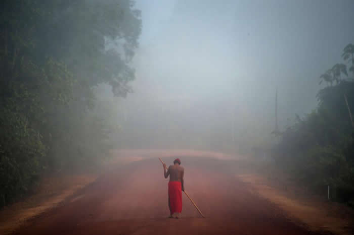 巴西阿马帕州（Amapa），怀亚皮原住民保留区的马尼利亚（Manilha）村里，走在雾中的部落头目札科．怀亚皮（Tzako Waiapi）。在亚马逊地区，尚未接